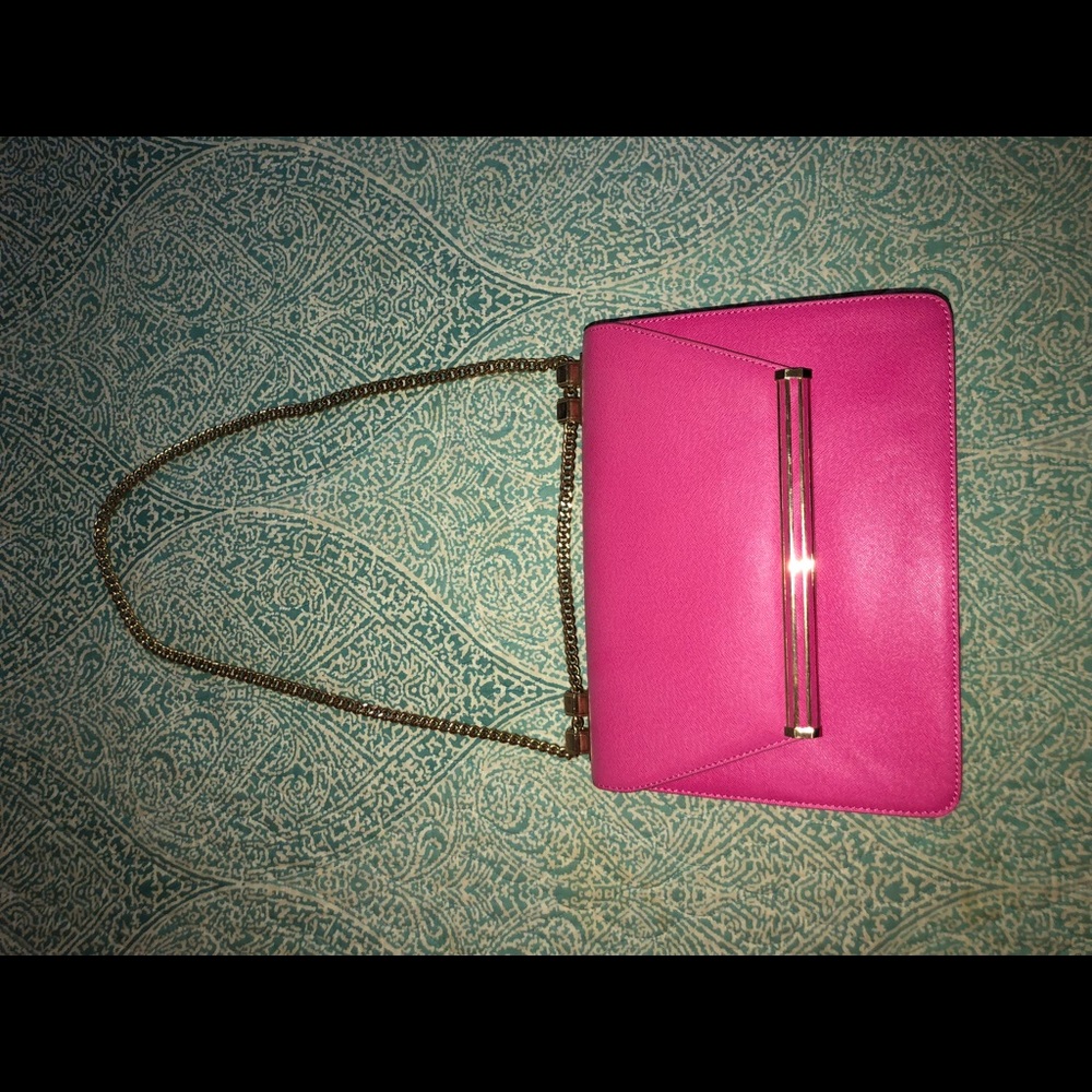 Pink medium size purse with gold chain strap.